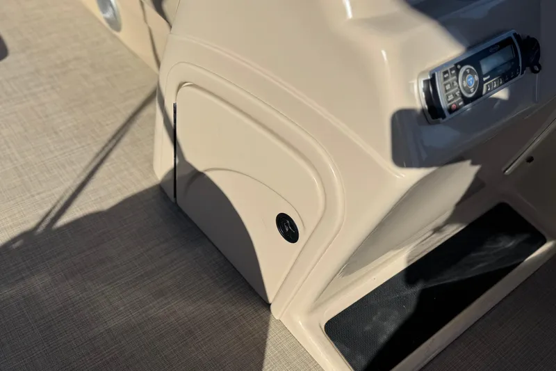 Slide: The Image of 2019 Sun Tracker SportFish 22 DLX console with stereo system and storage compartment. - 28