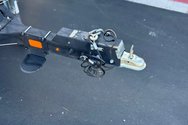 Slide: The Image of Trailer hitch of a 2019 Sun Tracker SportFish 22 DLX on asphalt surface. - 31