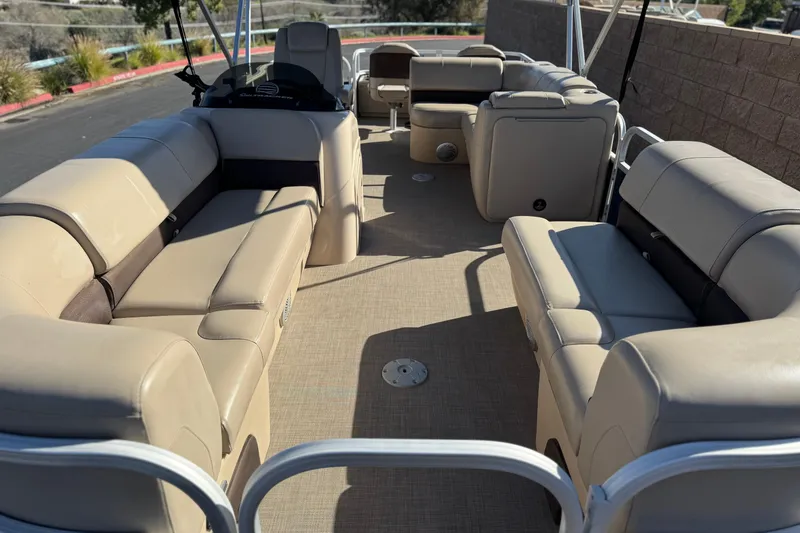 Slide: The Image of 2019 Sun Tracker SportFish 22 DLX pontoon boat with spacious seating and beige upholstery. - 9