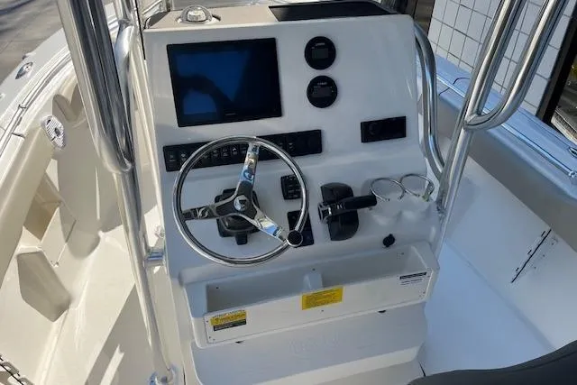 Slide: The Image of 2026 Key West 239 FS boat console with steering wheel and navigation controls. - 11