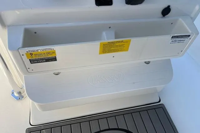 Slide: The Image of 2026 Key West 239 FS boat interior with storage compartment and capacity label. - 15