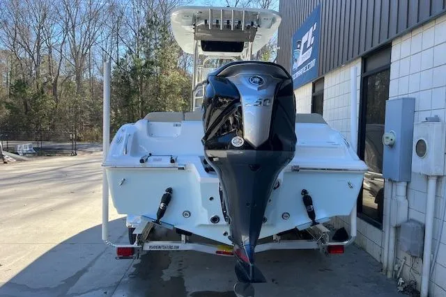 Slide: The Image of 2026 Key West 239 FS boat with powerful outboard motor, parked outdoors. - 4