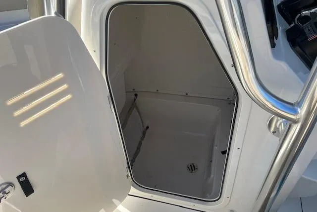 Slide: The Image of 2026 Key West 239 FS boat storage compartment with open door. - 5