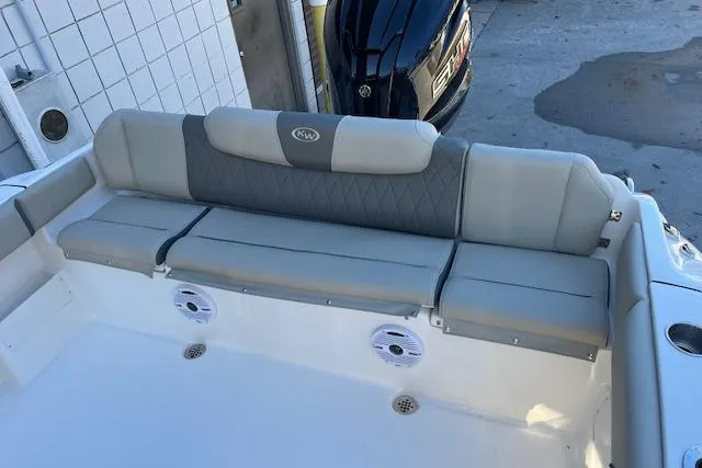 Slide: The Image of 2026 Key West 239 FS boat interior with cushioned seating and built-in speakers. - 6
