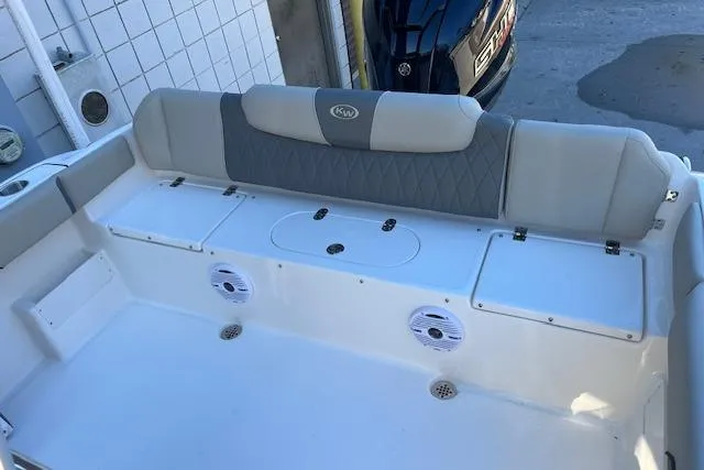 Slide: The Image of 2026 Key West 239 FS boat interior with cushioned seating and built-in speakers. - 7