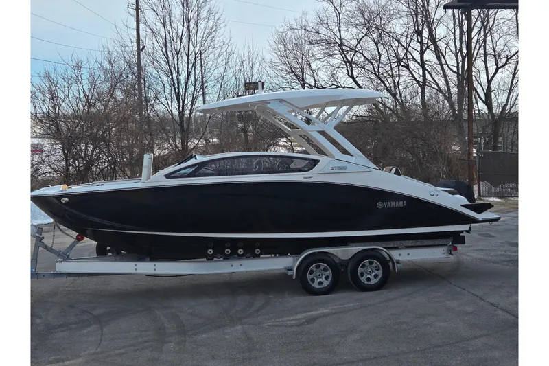 The Image of 2022 Yamaha Boats 275SD on trailer, sleek black design, parked outdoors. - 0