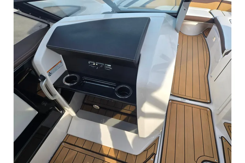 Slide: The Image of 2022 Yamaha Boats 275SD interior with teak flooring and cup holders. - 14