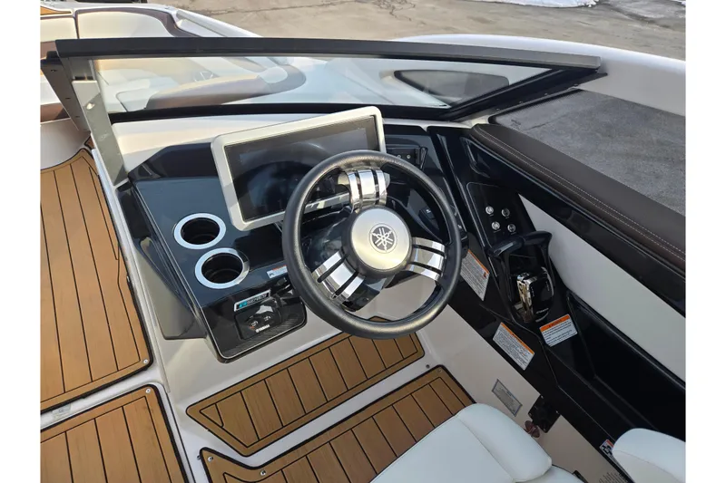 Slide: The Image of 2022 Yamaha Boats 275SD dashboard with steering wheel and digital display. - 17