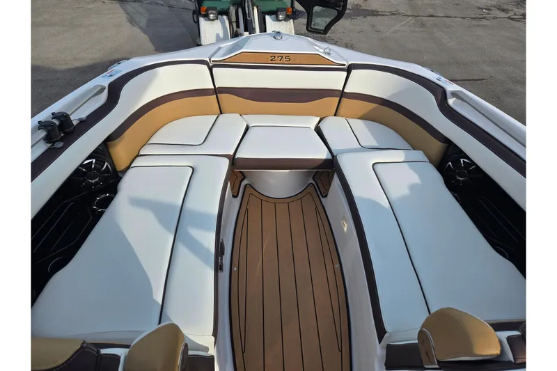 Slide: The Image of 2022 Yamaha Boats 275SD interior with luxurious seating and sleek design. - 19