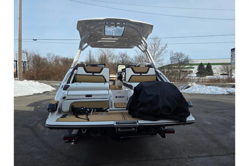 Slide: The Image of 2022 Yamaha Boats 275SD, rear view, showcasing spacious seating and sleek design. - 2