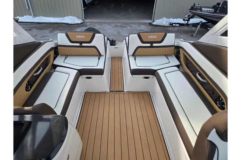 Slide: The Image of 2022 Yamaha Boats 275SD interior with luxurious seating and teak-style flooring. - 25