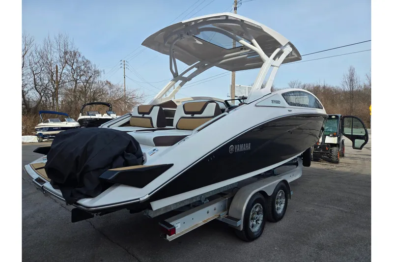 Slide: The Image of 2022 Yamaha Boats 275SD on trailer, sleek design, parked outdoors. - 3