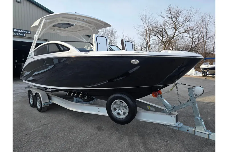 Slide: The Image of 2022 Yamaha Boats 275SD on trailer, sleek black design, parked outdoors. - 5
