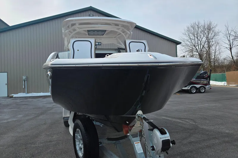 Slide: The Image of 2022 Yamaha Boats 275SD on trailer, parked outdoors near a building. - 6