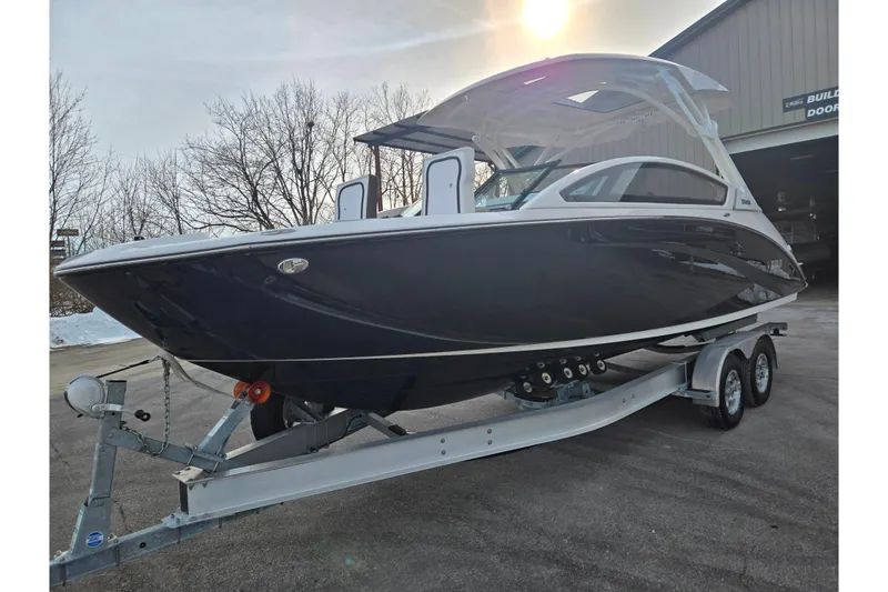 Slide: The Image of 2022 Yamaha Boats 275SD on trailer, sleek design, parked outdoors. - 8