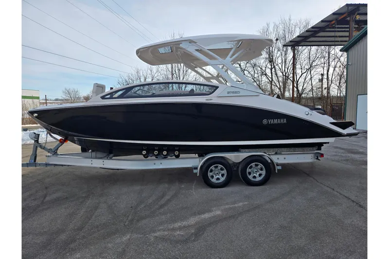 Slide: The Image of 2022 Yamaha Boats 275SD on trailer, sleek black design, parked outdoors. - 9