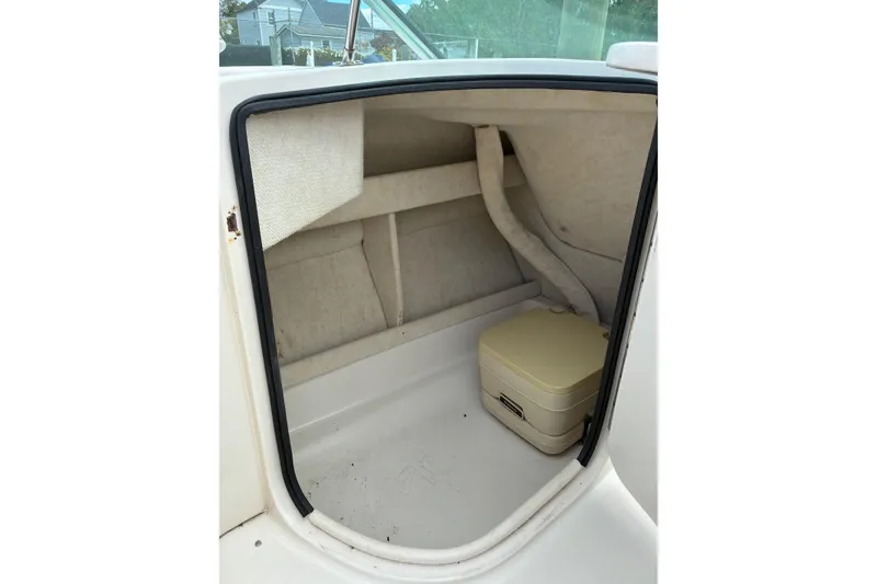 Slide: The Image of Interior cabin of 1999 Sea Ray 210 Sundeck with portable toilet. - 8