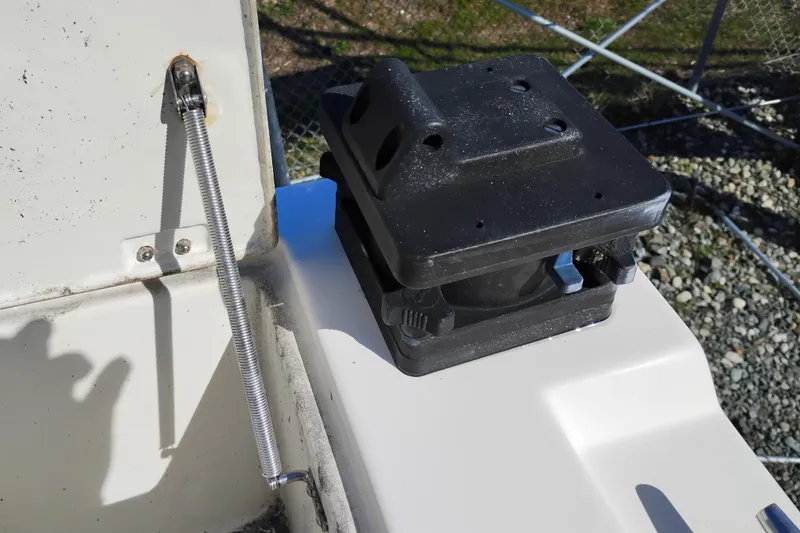 Slide: The Image of 1997 SeaSport Explorer 2400 boat detail with black mount and metal spring mechanism. - 11