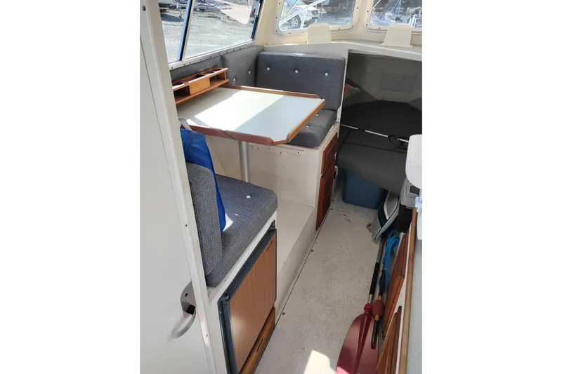 Slide: The Image of Interior of 1997 SeaSport Explorer 2400 boat with seating and table. - 15