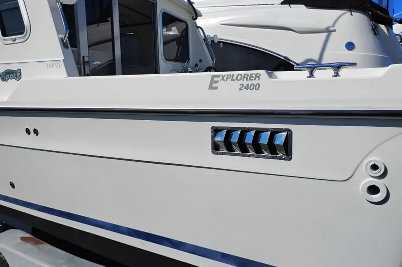 Slide: The Image of 1997 SeaSport Explorer 2400 boat side view, showcasing sleek design and branding details. - 3