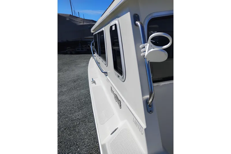 Slide: The Image of Side view of a 1997 SeaSport Explorer 2400 boat, showcasing sleek design and chrome details. - 12