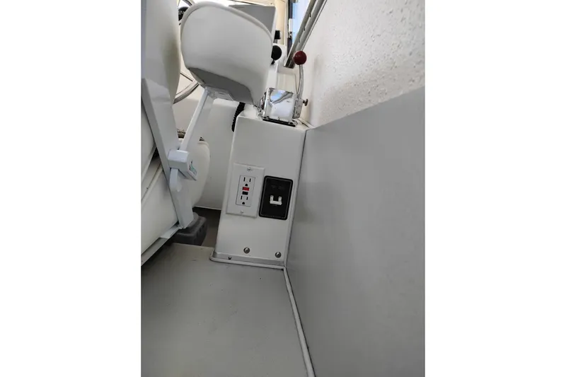 Slide: The Image of Interior view of a 1997 SeaSport Explorer 2400 boat, featuring a control panel. - 27