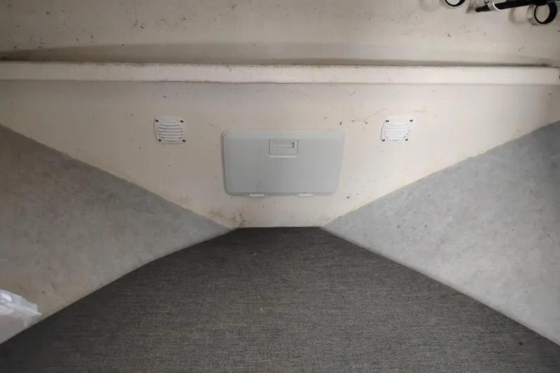 Slide: The Image of Interior cabin view of a 1997 SeaSport Explorer 2400 boat, featuring carpeted flooring. - 32
