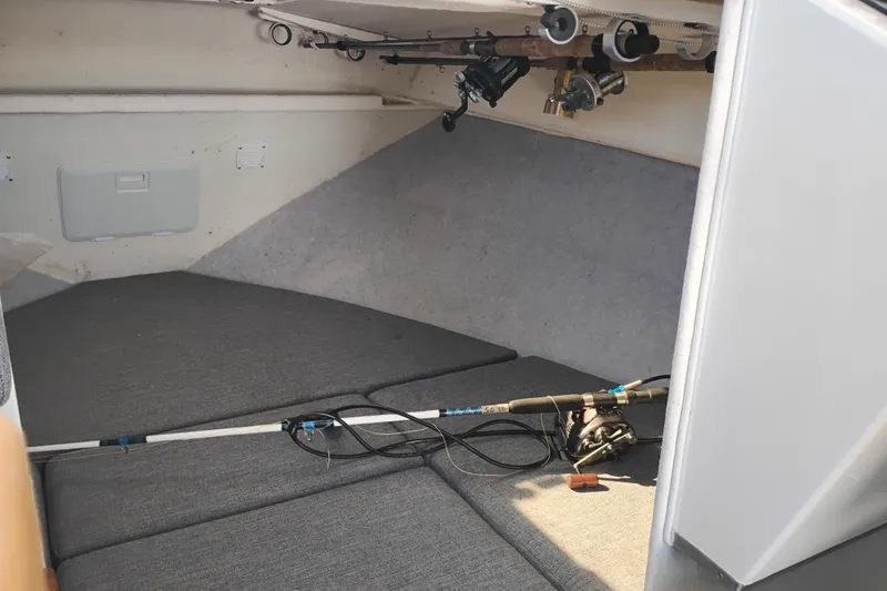 Slide: The Image of 1997 SeaSport Explorer 2400 cabin interior with fishing rods and gear. - 33