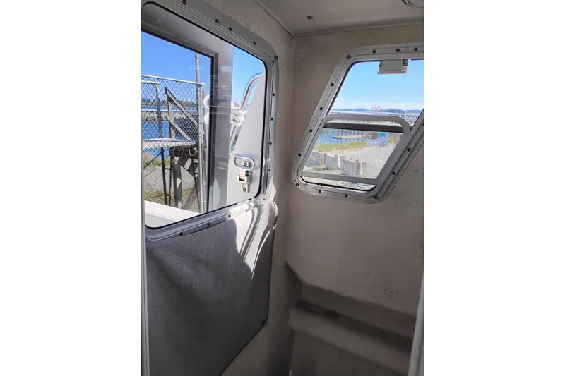 Slide: The Image of Interior view of 1997 SeaSport Explorer 2400 boat with windows and outdoor scenery. - 35