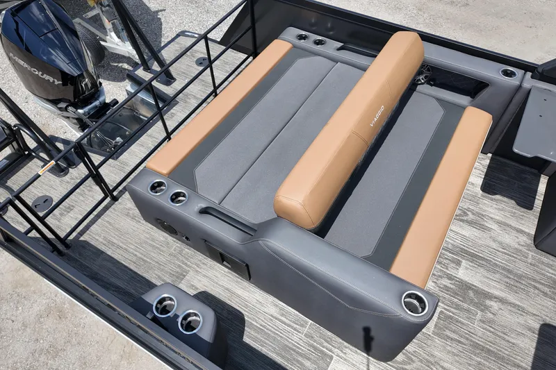 Slide: The Image of 2026 Viaggio Diamante 24 S boat interior with tan and gray seating, cup holders, and Mercury engine. - 11