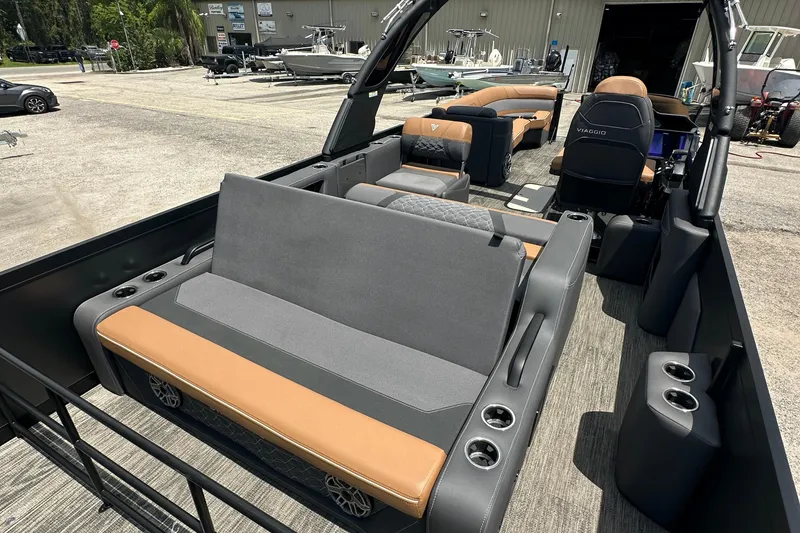 Slide: The Image of 2026 Viaggio Diamante 24 S pontoon boat interior with luxurious seating and cup holders. - 13