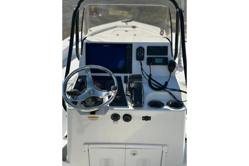 Slide: The Image of 2025 BlackJack 224 boat dashboard with steering wheel, navigation controls, and display screen. - 3