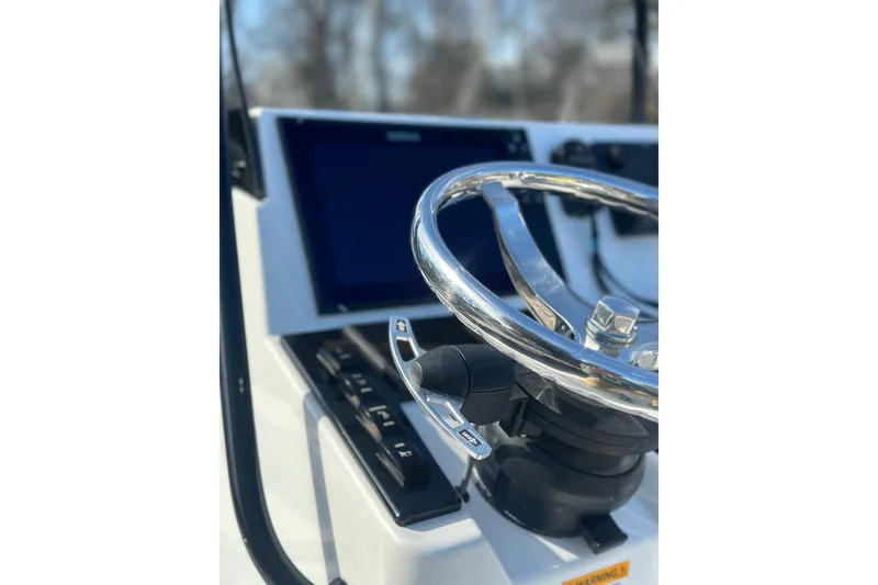 Slide: The Image of Steering wheel of 2025 BlackJack 224 boat with modern dashboard controls. - 4