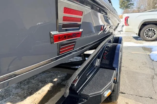 Slide: The Image of 2026 Vexus VXs20 boat on trailer, close-up view of model badge. - 11