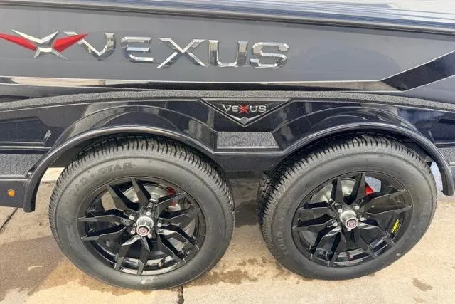 Slide: The Image of 2026 Vexus VXs20 trailer with dual black wheels and sleek design. - 12