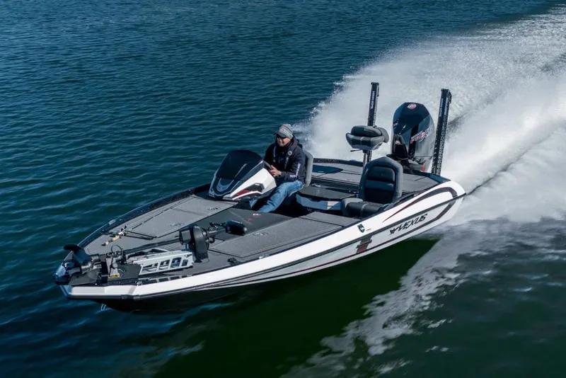 Slide: The Image of Manufacturer Provided Image: 2026 Vexus VXs20 boat speeding on water with driver, showcasing sleek design and performance. - 13