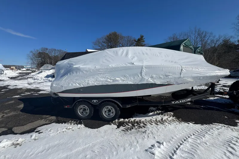 Slide: The Image of Covered 2023 Tahoe 1950 boat on trailer in snowy outdoor setting. - 4