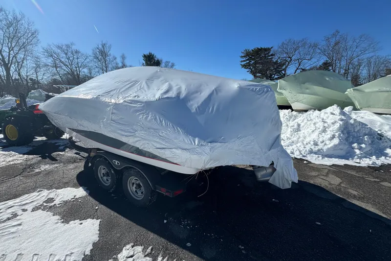 Slide: The Image of Covered 2023 Tahoe 1950 boat on trailer in snowy outdoor setting. - 5