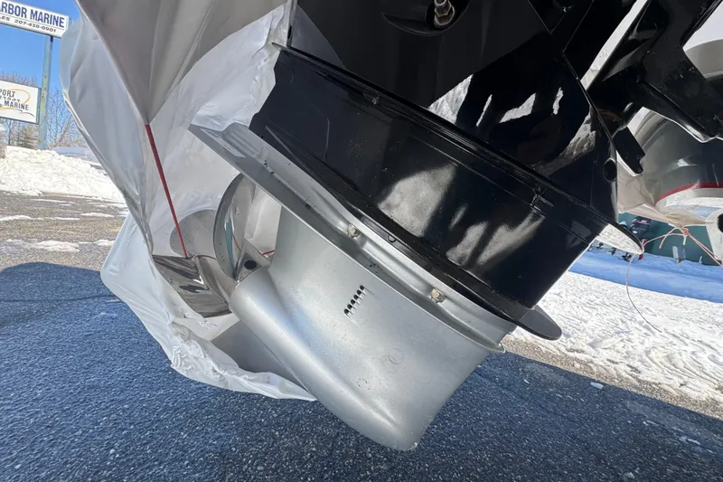 Slide: The Image of Close-up of a 2023 Tahoe 1950 boat motor, partially covered, on a snowy day. - 7