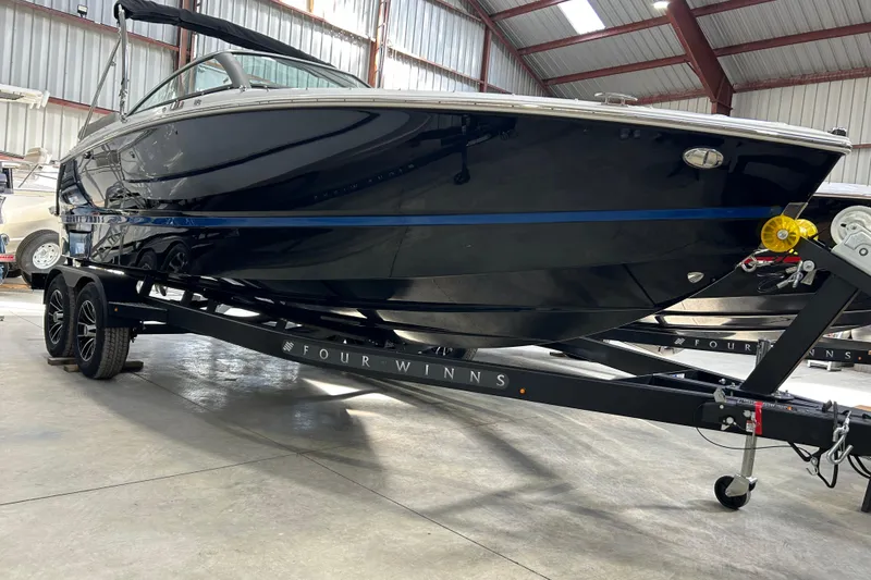 Slide: The Image of 2026 Four Winns H2 boat on trailer in warehouse setting. - 11