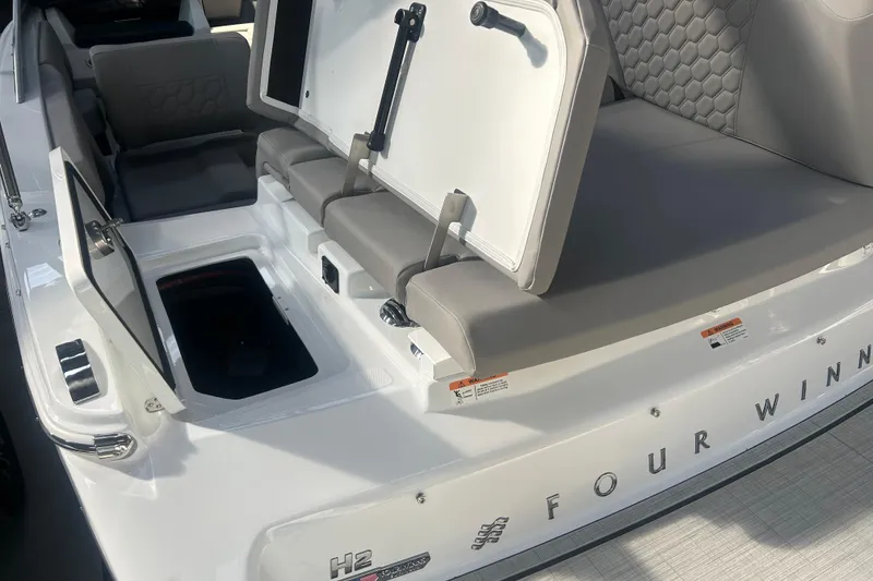 Slide: The Image of 2026 Four Winns H2 boat interior with open storage compartments and cushioned seating. - 19