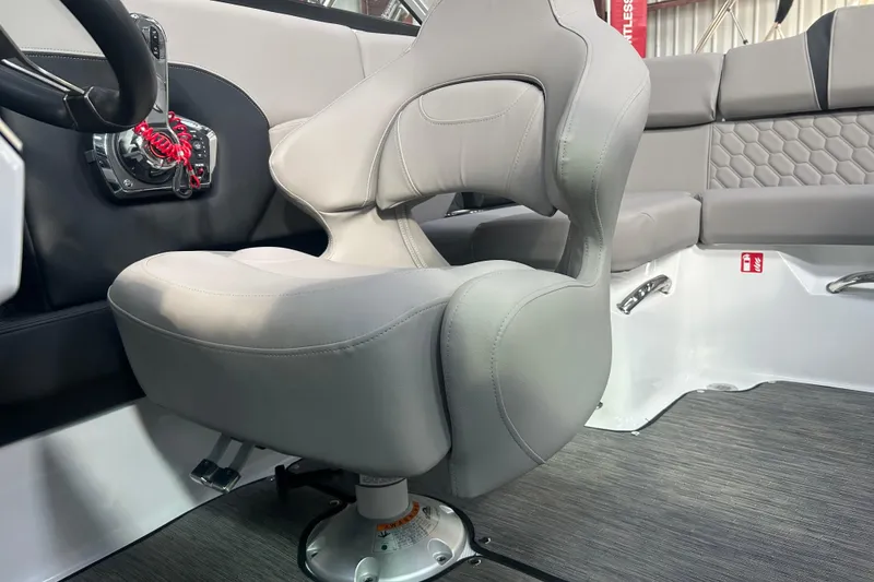 Slide: The Image of 2026 Four Winns H2 boat interior with gray captain's chair and modern dashboard. - 22