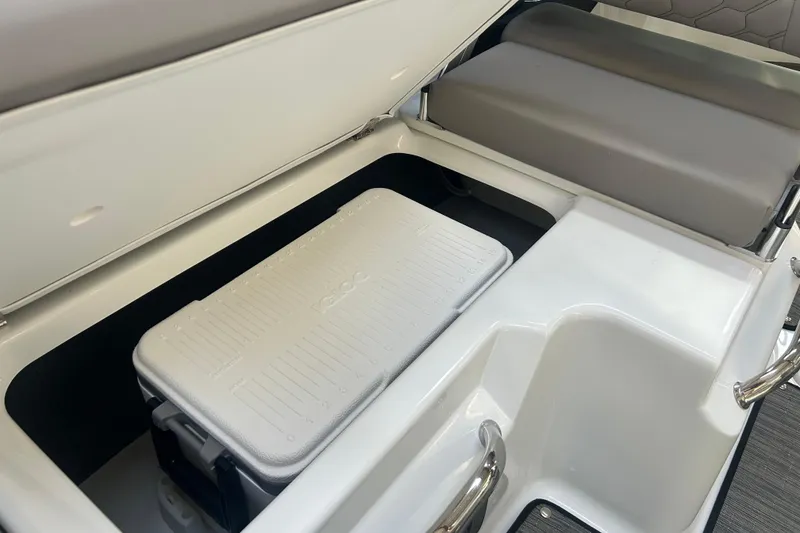 Slide: The Image of 2026 Four Winns H2 boat storage compartment with cooler and seating area. - 27