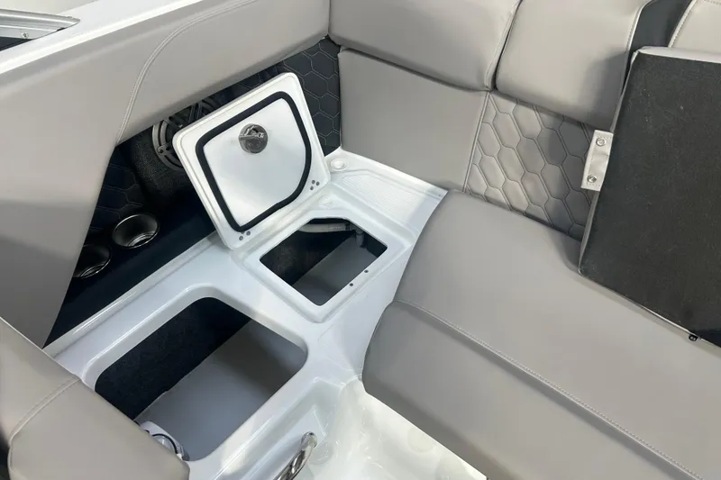 Slide: The Image of 2026 Four Winns H2 boat interior with open storage compartment and gray seating. - 28