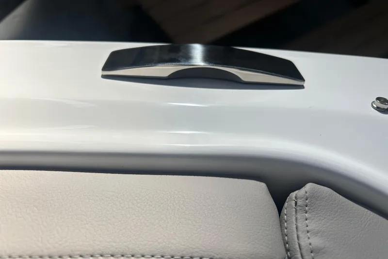 Slide: The Image of 2026 Four Winns H2 boat interior detail with sleek handle and white upholstery. - 34