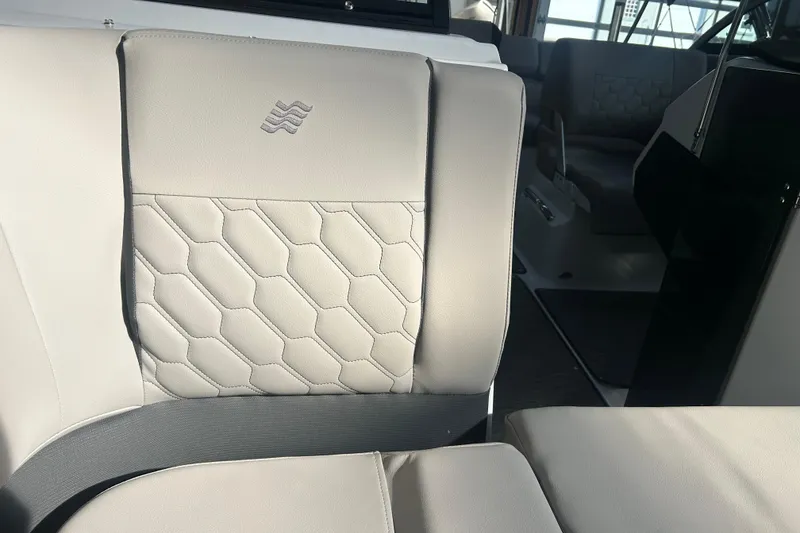 Slide: The Image of 2026 Four Winns H2 boat interior with elegant beige seating and hexagonal stitching. - 35