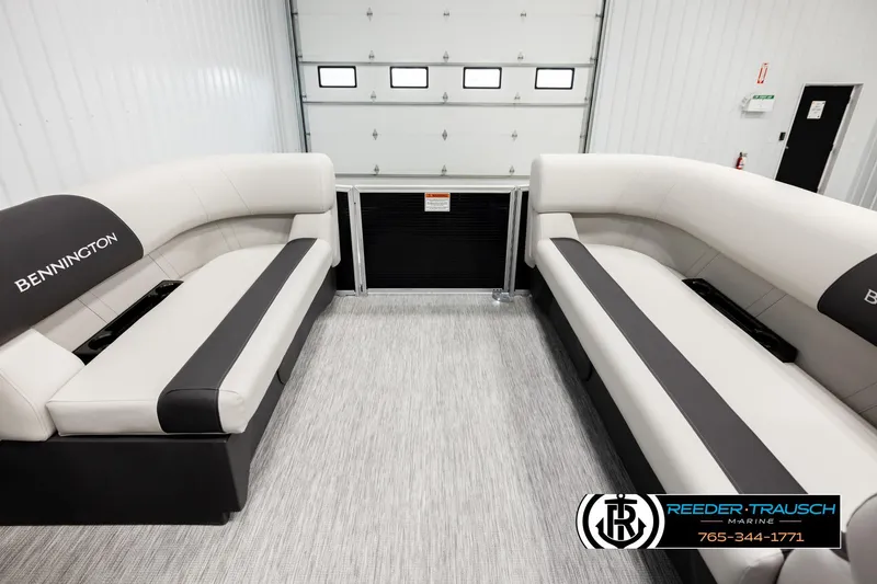 Slide: The Image of 2026 Bennington SLSF boat interior with luxurious seating in a showroom. - 18