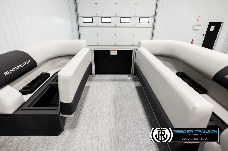 Slide: The Image of 2026 Bennington SLSF boat interior with plush seating in a showroom. - 19