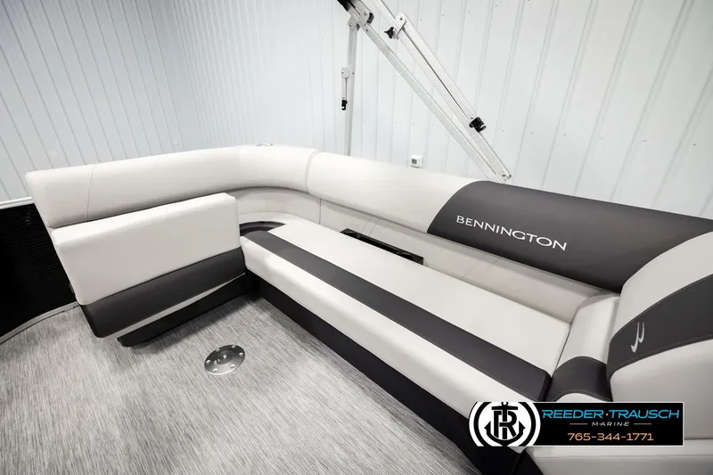 Slide: The Image of 2026 Bennington SLSF boat interior with sleek, modern seating in a showroom. - 22