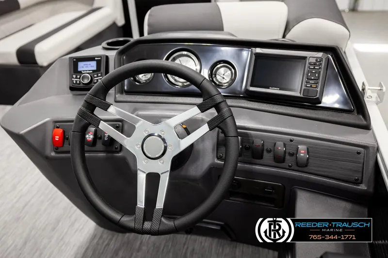 Slide: The Image of 2026 Bennington SLSF boat dashboard with steering wheel and control panel. - 26